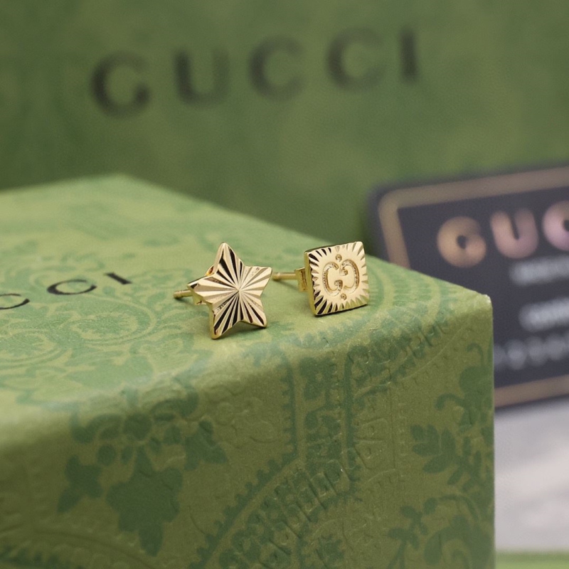 G*u*i earrings
